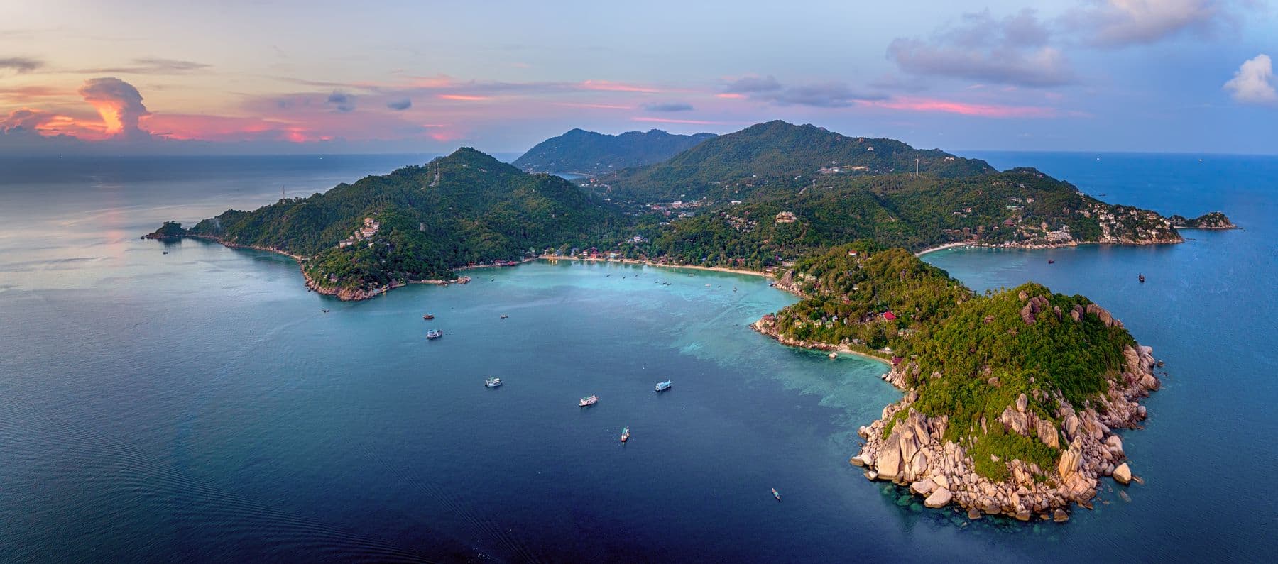 A green peninsula and turquoise bays around Koh Tao at sunset